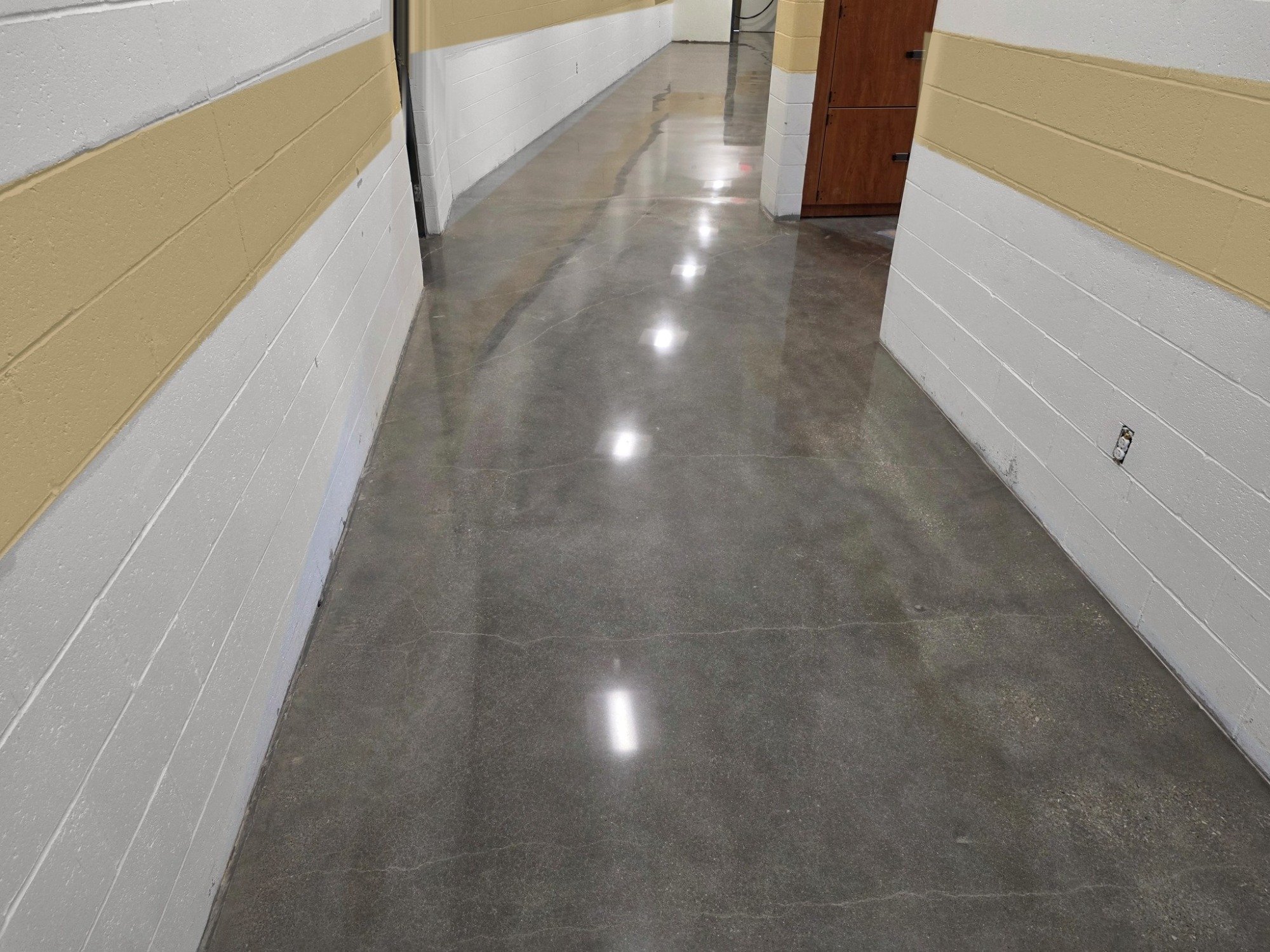 High-gloss polished concrete school hallway.