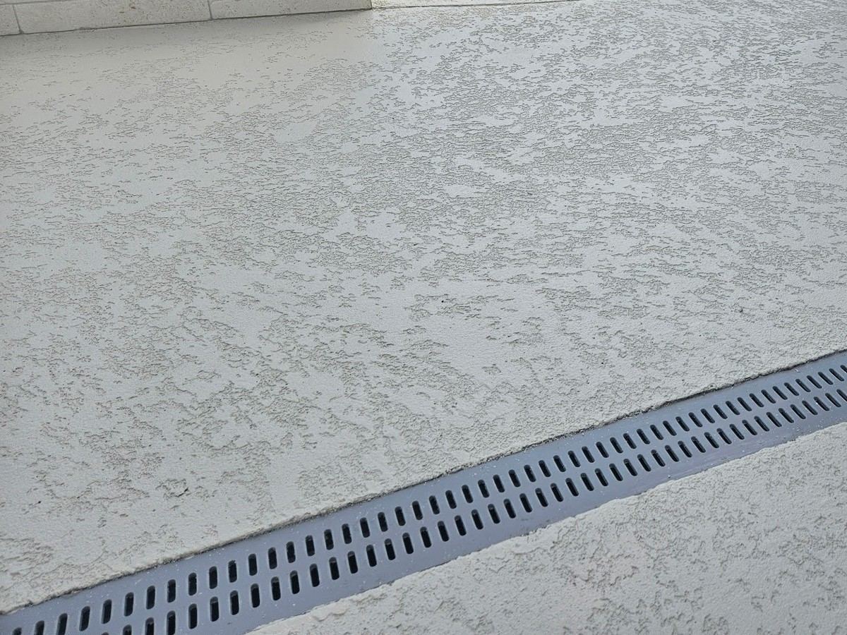 Light gray knockdown overlay beside a trench drain.